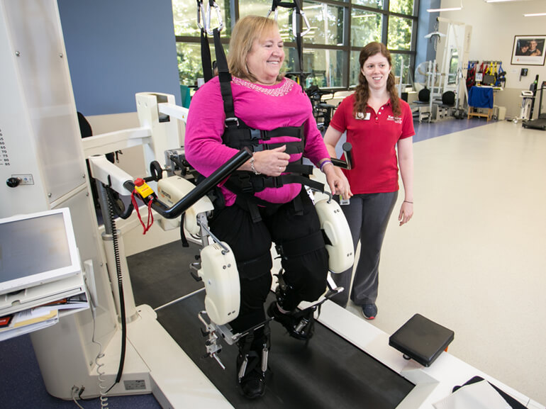 spinal cord injury patient working with physical therapist