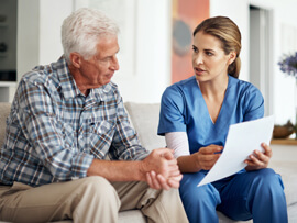 therapist speaking to patient about Medicare paperwork