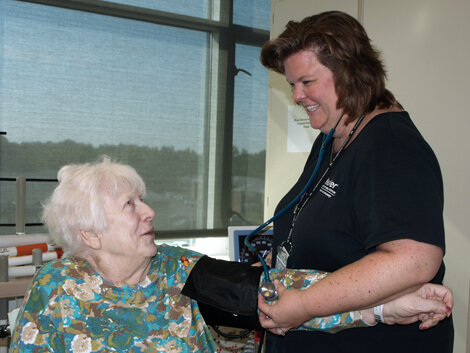 older female patient working with physical therapist