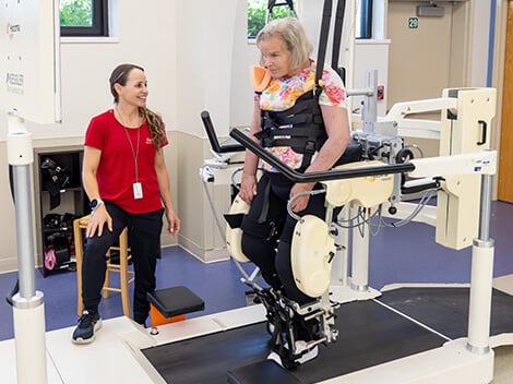 Outpatient rehabilitation patient on a treadmill, working with physical therapist.