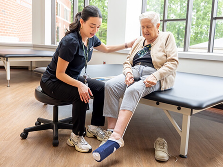 patient working with physical therapist