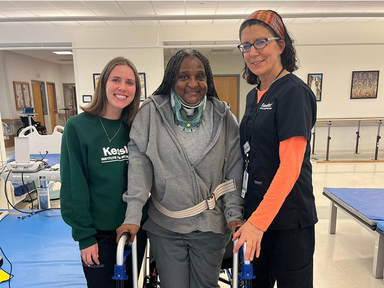 Photo of Leslie Segars with her therapists at Kessler Institute for Rehabilitation.
