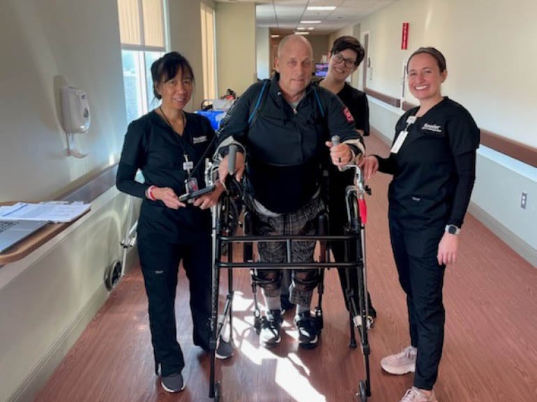 Photo of Mike Thompson and his therapists at Kessler Institute for Rehabilitation - Marlton.