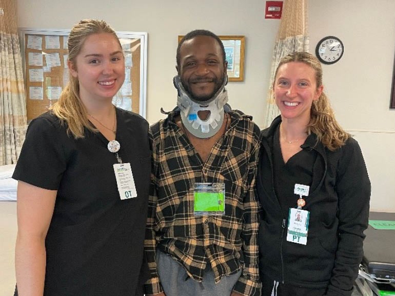Photo of Tavion Williams and his therapists at Kessler Institute for Rehabilitation.