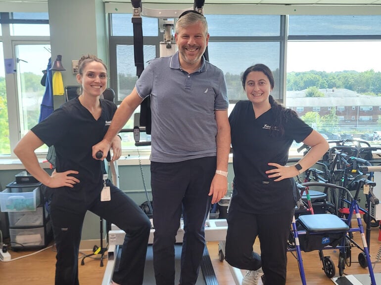 Photo of Jack Weiss and his therapists at Kessler Institute for Rehabilitation.