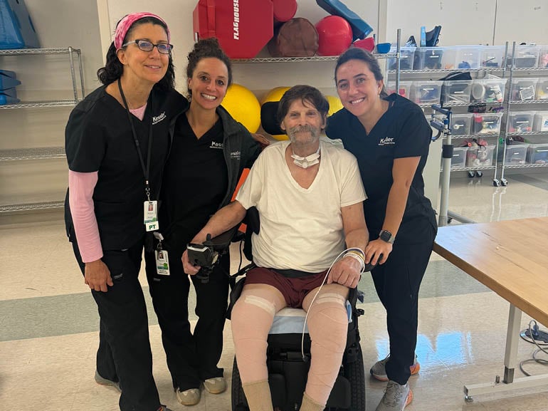 Photo of George Scott III and his therapists at Kessler Institute for Rehabilitation.