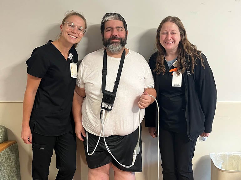 Photo of Richard Pingitor with his therapists at Kessler Institute for Rehabilitation.