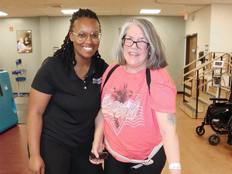 Photo of Christina Taylor and her therapist at Kessler Institute for Rehabilitation.
